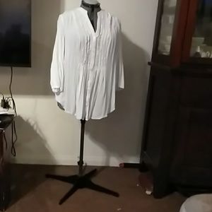 A long sleeved blouse with tuxedo ruffles.